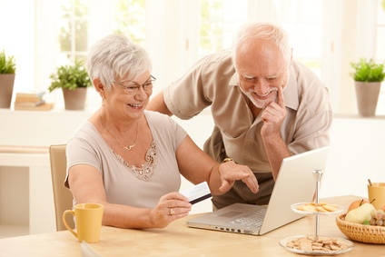 Happy older couple doing online shopping